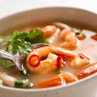 14. Tom Yum Soup · Spicy soup with a touch of lemongrass, galangal root, kaffir leaves, tomatoes, onions, mushr...