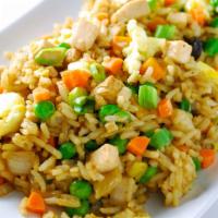 Thai Fried Rice · Fried rice with onions, tomatoes, peas, and carrots topped with cilantro, and cucumber.