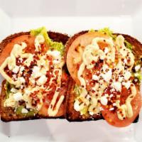 Moroccan · Hummus, Feta, Tomato, Lemon Juice, Red Pepper Flakes. Served open-faced on sliced 7-grain br...