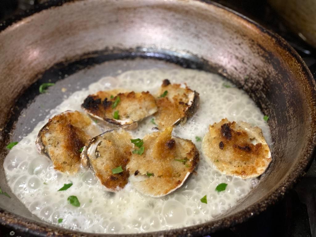 Baked Clams Oreganata · Baked clams seasoned with bread crumbs and finished with white wine sauce.