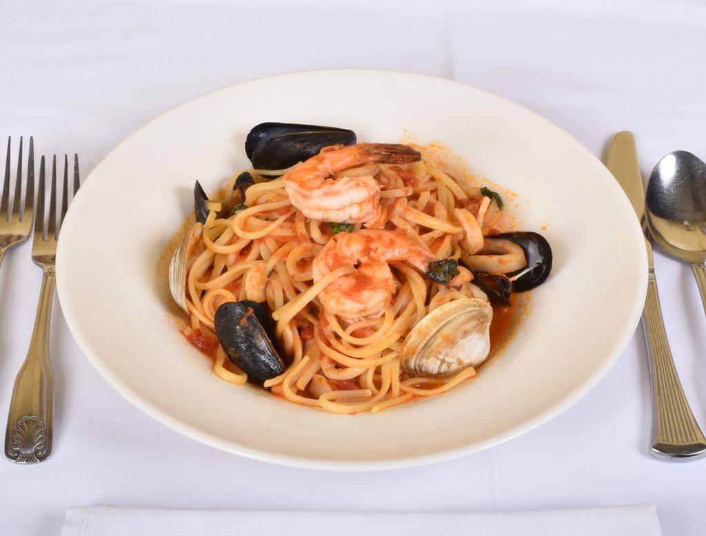 Linguine Frutti di Mare Dinner · Clams, lobster tail, calamari, mussels and shrimp with red sauce over linguini.