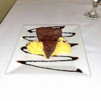 Flourless Chocolate Cake · Made from Premier Callebaut Semi-Sweet Chocolate, served with a scoop of vanilla ice cream (...