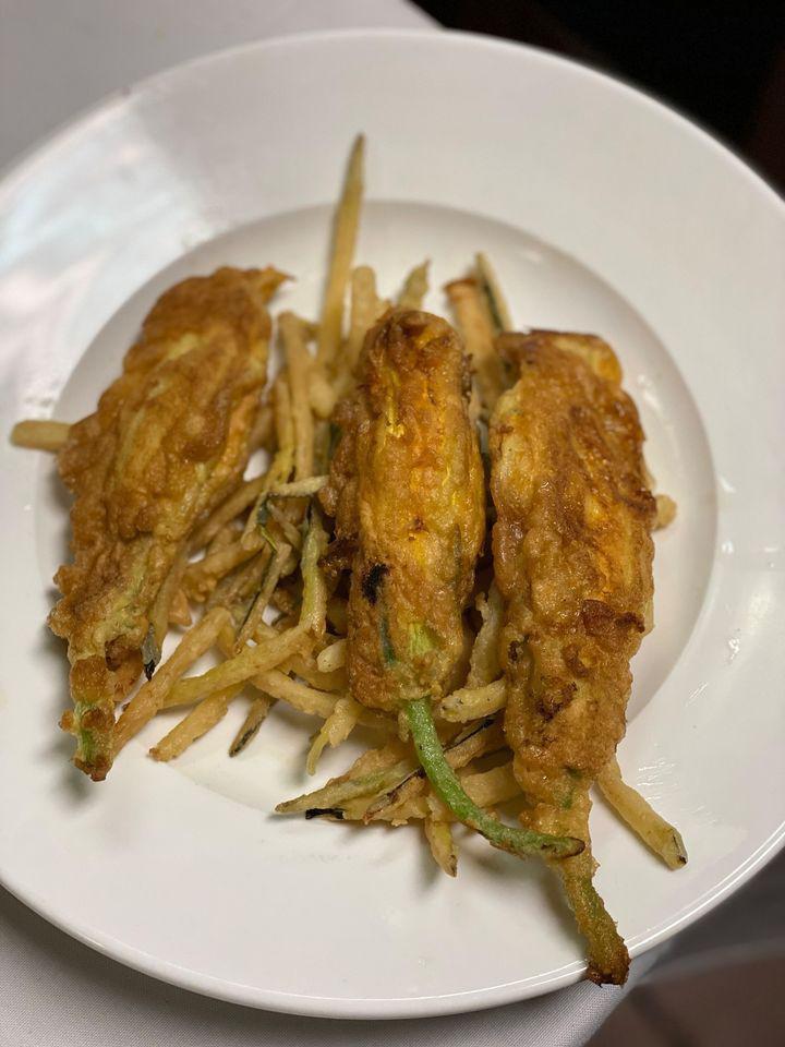 Stuffed Zucchini Blossoms · Garden fresh zucchini flowers stuffed with goat cheese, battered and fried, over a bed of julienned zucchinis