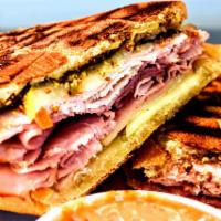 Cuban Panini · Roasted pork, smoked ham and cheese swiss cheese with sliced dill pickles, whole grain musta...