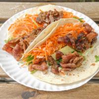 Grilled Pork Tacos · Vietnamese style marinated pork in 2 soft corn tortillas with butter, mayo, crispy pickled c...