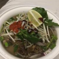 Grilled Pork Pho · Rice vermicelli noodles in slow-simmered seasoned beef broth, fresh bean sprouts, Thai basil...