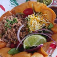 Taco Salad · Served in a taco shell with lettuce, red onion, tomatoes, shredded cheese, guacamole, & sour...