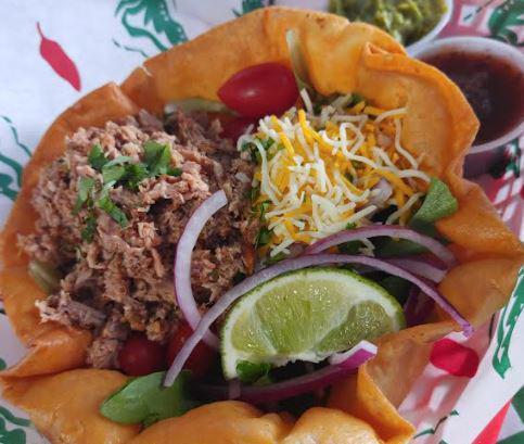 Taco Salad · Served in a taco shell with lettuce, red onion, tomatoes, shredded cheese, guacamole, & sour cream with your choice of chicken or smoked pork.