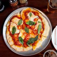 Margherita Pizza · fresh mozzarella, cherry tomato, basil. Sour dough crust