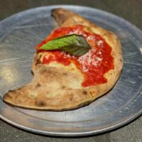 Calzone Classico · Fresh mozzarella, Ricotta, Prosciutto Cotto (Ham), topped with tomato sauce and basil