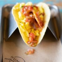 Breakfast Taco · Scrambled eggs, bacon, cheese and salsa wrapped up in a warm tortilla.
