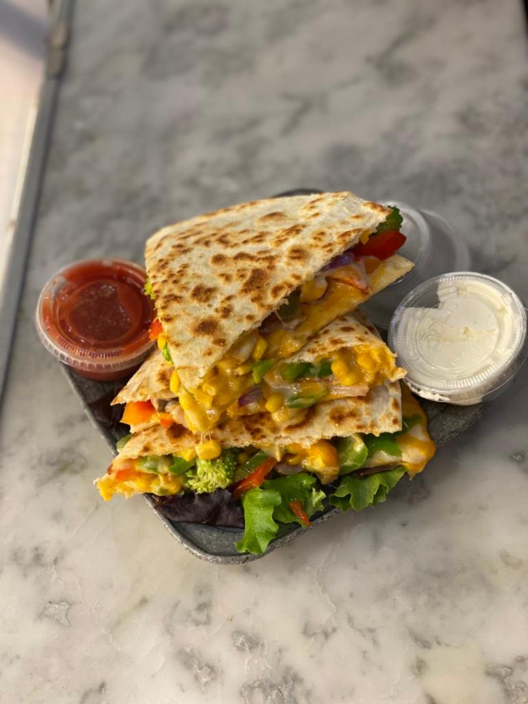 VEGGIE QUESADILLA  · Grilled Peppers, Grilled Onions, Grilled Mushrooms , Broccoli, Corn , Cheddar Cheese and Pepper Jack Cheese 