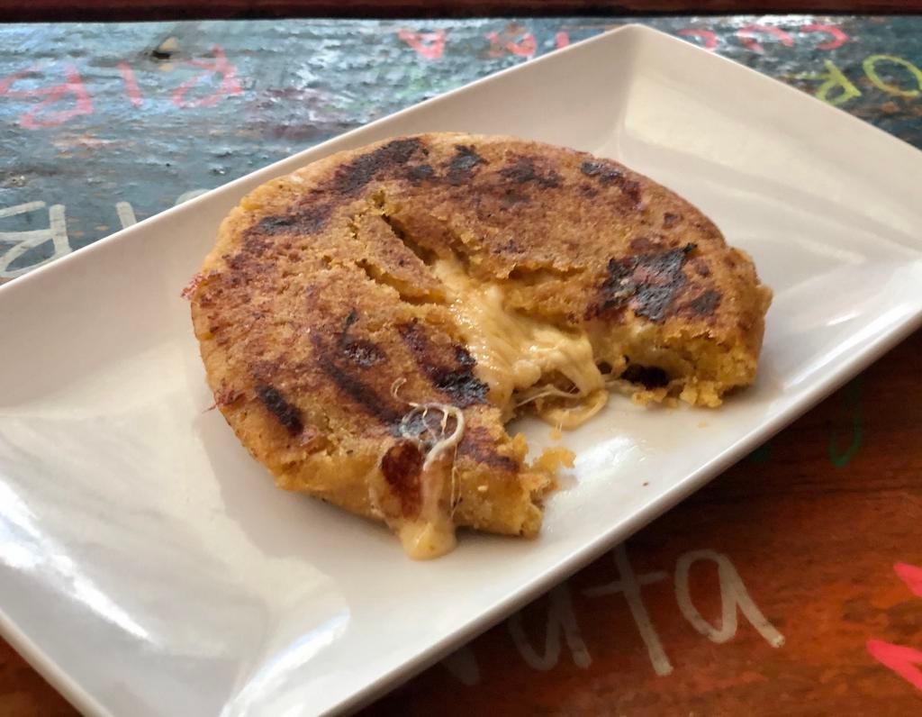 Plantain Arepa · A fullmoon patty dough made from ripe plantains and stuffed with cheese, jalapeño and chipotle peppers