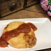 Pupusa · A thick griddle cake from El Salvador made with cornmeal and stuffed with cheese and pork