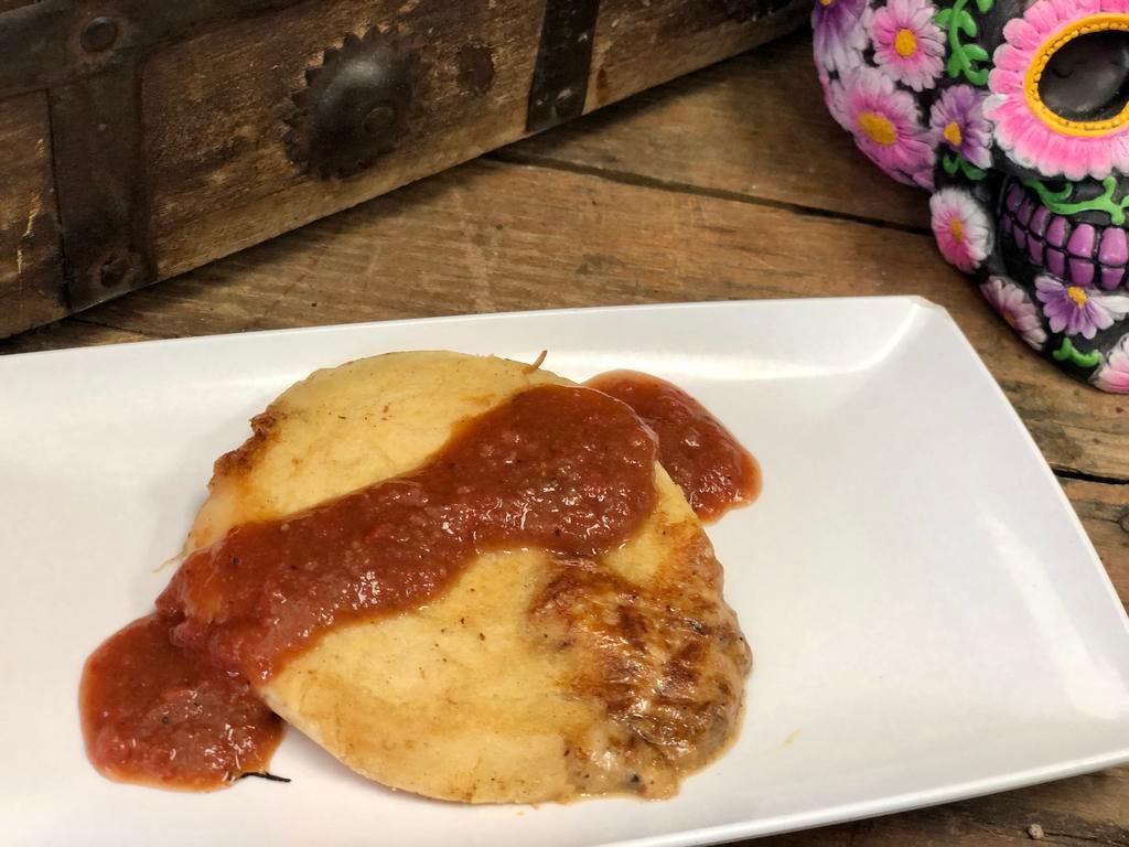 Pupusa · A thick griddle cake from El Salvador made with cornmeal and stuffed with cheese and pork