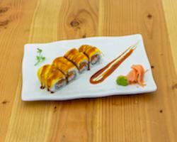 Mangolian Deluxe Roll · Crunchy spicy tuna, kani topped with mango and drops of sweet sauce.