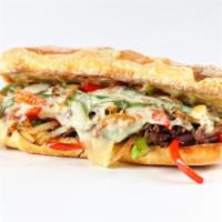 The Philly Cheesesteak with Onions and Peppers · Sandwich with tiny strips of sliced beef steak, onions, peppers, and melted cheese on a hero...