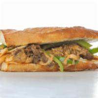 The Chicken Philly Cheesesteak Sandwich with Onions and Peppers · Sandwich with strips of chicken, onions, bell peppers, and melted cheese on a hero roll.
