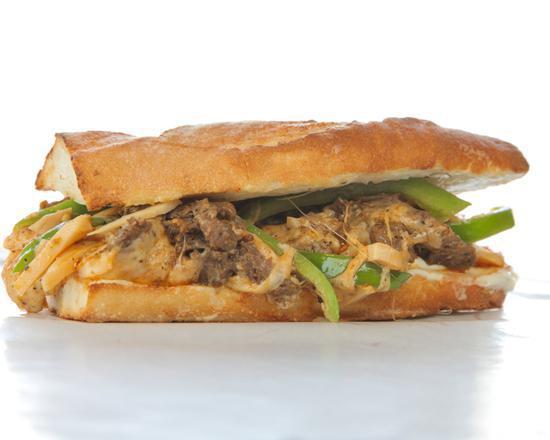 The Chicken Philly Cheesesteak Sandwich with Onions and Peppers · Sandwich with strips of chicken, onions, bell peppers, and melted cheese on a hero roll.
