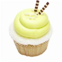 Pina Coloda Cupcake · A vanilla cupcake topped with coconut frosting, a piece of pineapple, and coconut.