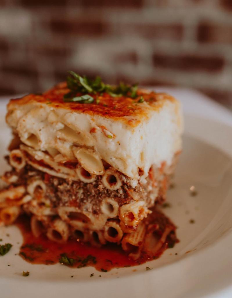 Pastitsio · Baked macaroni, spiced ground beef tomato sauce and bechame.