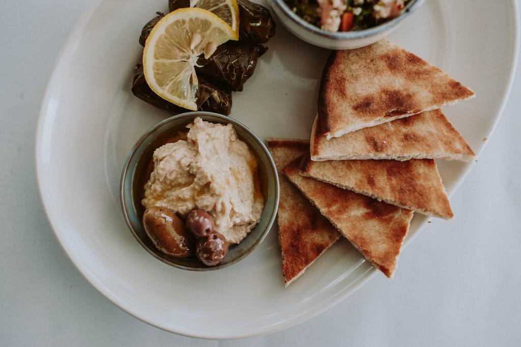 Vegetarian Greek Platter · Dolmas, tabouli, spanakopita, hummus, feta, olives, toasted pita 