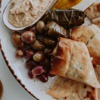 Greek Appetizers Plate · Assorted olives, feta cheese, spanakopita, dolmathes, hummus,  & toasted pita.
