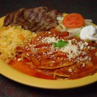 Entomatadas con Carne Azada · Soft corn tortillas stuffed with refried beans covered with special tomato garlic sauce and ...