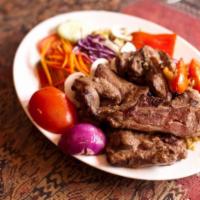 Lamb Steak · Lamb steak marinated and grilled. Served with rice, salad and Afghani bread. 