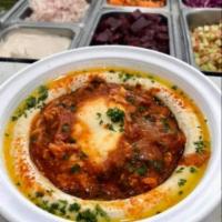 Humshuka · Hummus served with our famous shakshuka. Served with 2 pitas and a side of pickles.