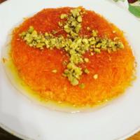 Knafeh · Shredded qatayef with cheese and a drizzled shower with sweet sugar syrup. Topped with pista...