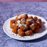 Parmesan Truffle Tots · Tater tots with fresh parmesan cheese, white truffle oil and chives