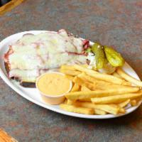 Grilled Reuben · Corned beef, melted Swiss cheese and sauerkraut. Served with french fries, coleslaw and pick...