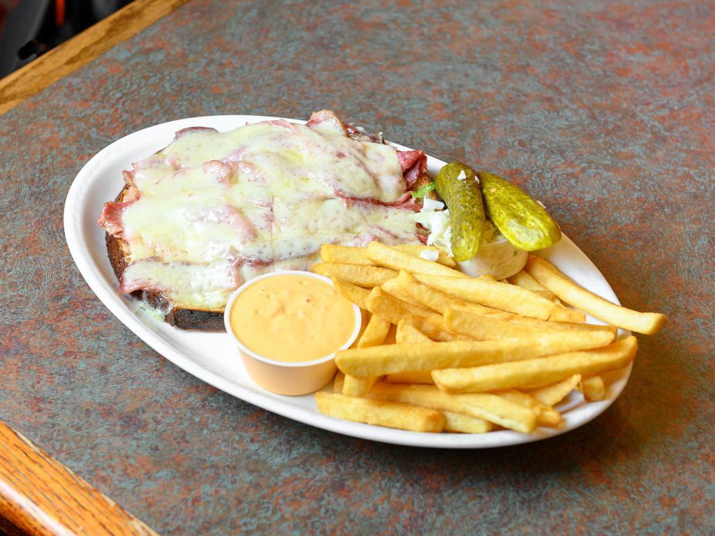 Grilled Reuben · Corned beef, melted Swiss cheese and sauerkraut. Served with french fries, coleslaw and pickle.