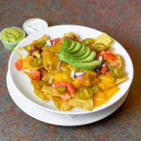 Nachos Grande · Corn tortilla chips topped with beef chili, jalapenos, shredded cheddar cheese, diced tomato...