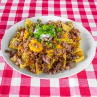Loaded Brisket Nachos · Comes with chopped brisket, beans, nacho cheese, sour cream, chives and jalapenos. 