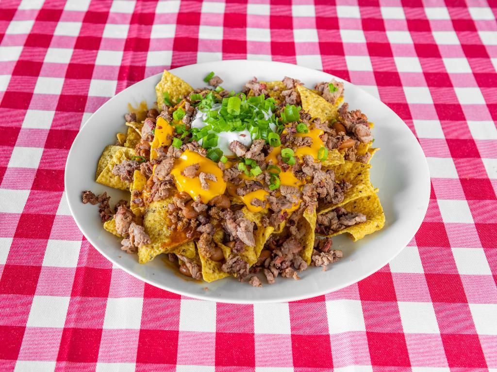 Loaded Brisket Nachos · Comes with chopped brisket, beans, nacho cheese, sour cream, chives and jalapenos. 