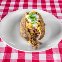 Loaded Brisket Baked Potato · Baked potato topped with chopped brisket. Toppings include butter, beans, shredded cheese, s...
