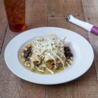 Brisket Enchiladas · New Mexican green Chile sauce, black bean rice, roasted corn salsa and cotija cheese.