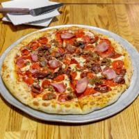 The Butcher Pizza · Spicy pizza sauce, mozzarella, pepperoni, homemade sausage, Canadian bacon, corned beef.