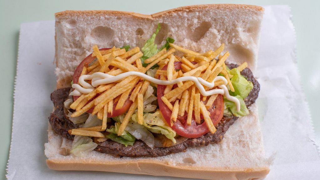 Pan con Bistec  · Cuban bread with steak, cooked onions, lettuce, tomatoes, mayonese and shoestring potatoes.