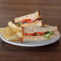 Smoked Ham and Cheddar Sandwich · Hand-sliced smoked ham and cheddar cheese layered with fresh Roma tomatoes and crisp lettuce...