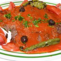 Iskender Kebab with Lamb · Thinly sliced lamb doner kebab meat with homemade croutons and special tomato sauce.