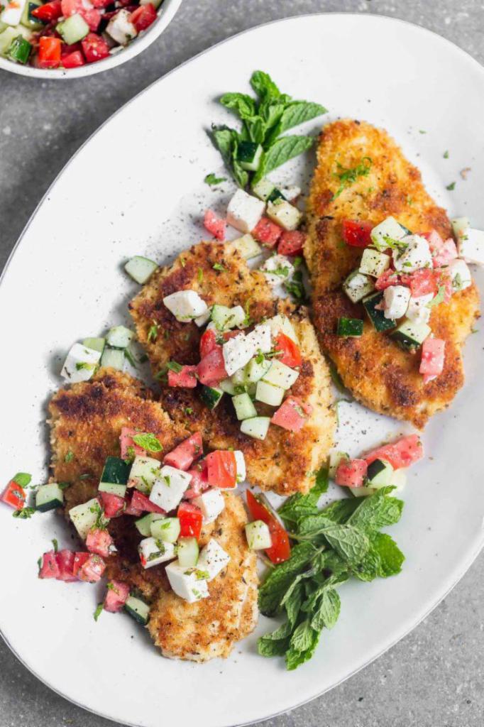 CHICKEN MILANESE  · Oversized chicken cutlet topped by mesclun salad Red onion cherry tomato and shaved Parmigiano 