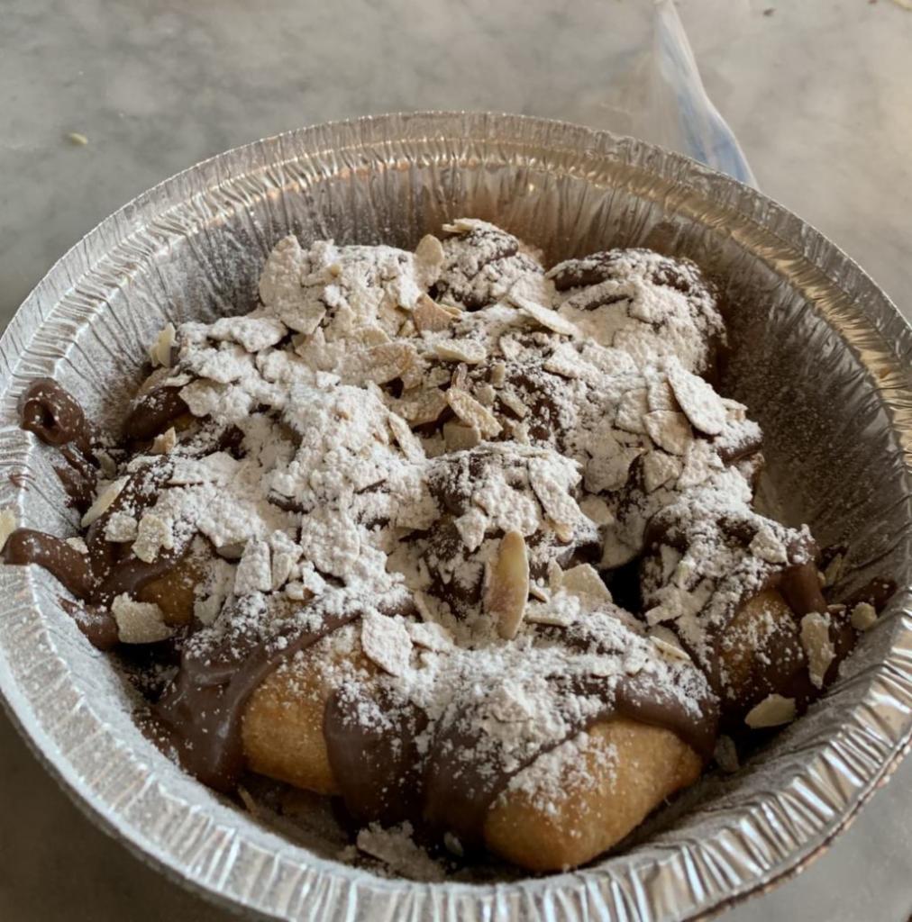 Fried Zeppole with Nutella · 12 pieces of our Delicious Zeppole Covered in Nutella and Powdered Sugar!