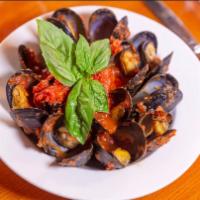 Mussels Posilipo · Sauteed mussels in a marinara sauce with linguine.