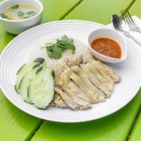 Khao Man Gai Tom (chicken & rice) · Chicken and rice. Boiled chicken and rice served with cucumber, cilantro, and Khao Man Gai s...