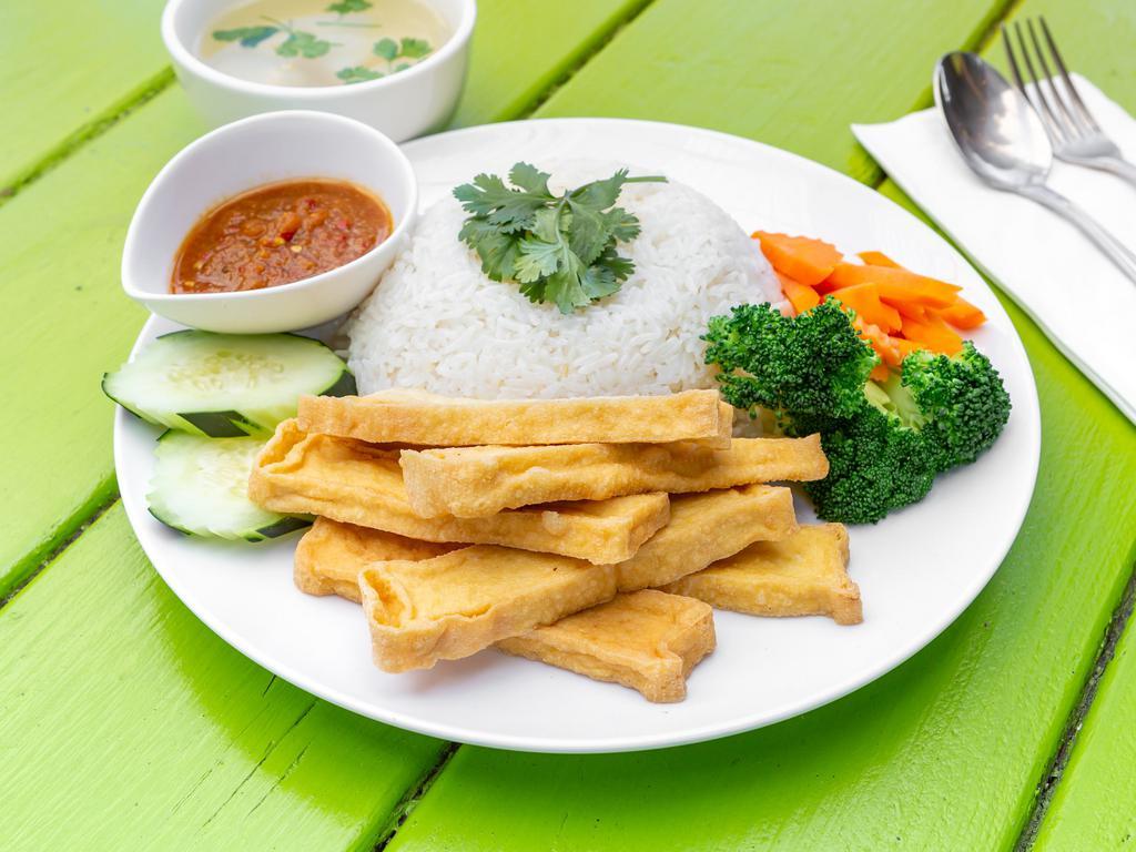Khao Man TOFU (tofu & rice) · Khao Man (Rice), crispy tofu served with stream broccoli , carrot , cucumber , cilantro and ginger sauce.