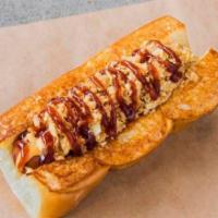 COWBOY · smoked bacon wrapped dog, cheese sauce, crispy onions, bbq sauce