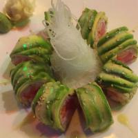 Marble Roll · Salmon, tuna and yellowtail wrapped with marble seaweed topped with avocado wasabi sauce.